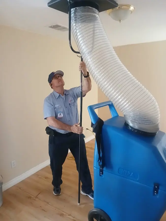 Furnace Tune-Up technician using HEPA equipment in Marathon